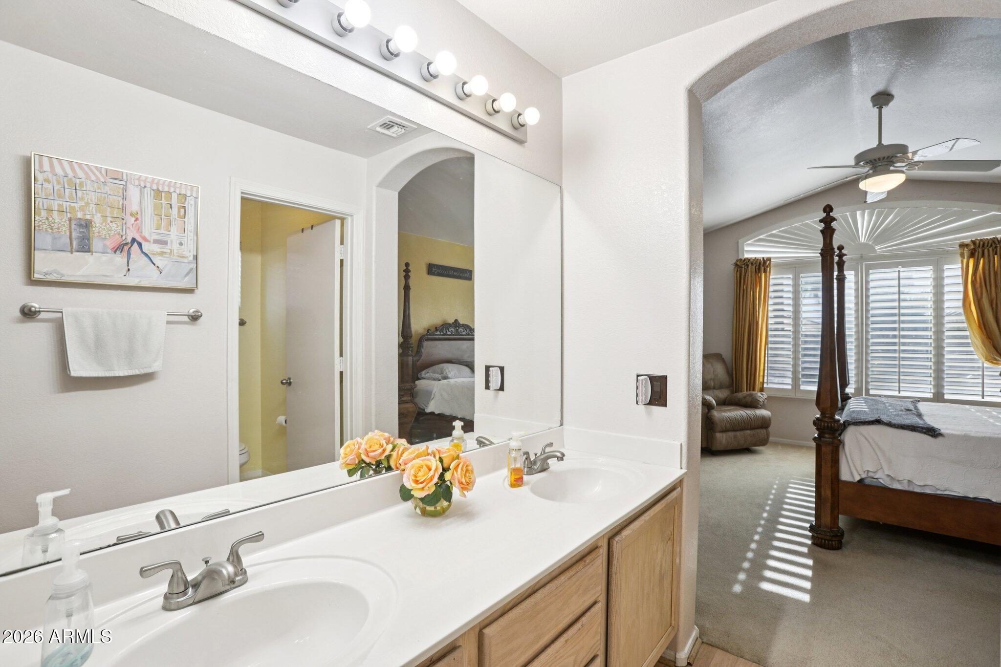 13414 South 47th Way Phoenix, AZ 85044 - Photo 23 of 32 a en suite bathroom with a double vanity sink and a mirror