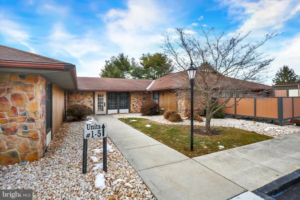 a swimming pool view with a seating space