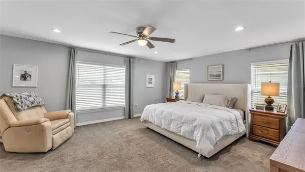 a bedroom with a bed couch and window