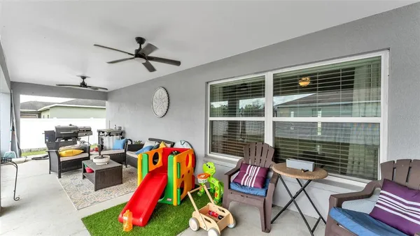 a living room with furniture and a floor to ceiling window