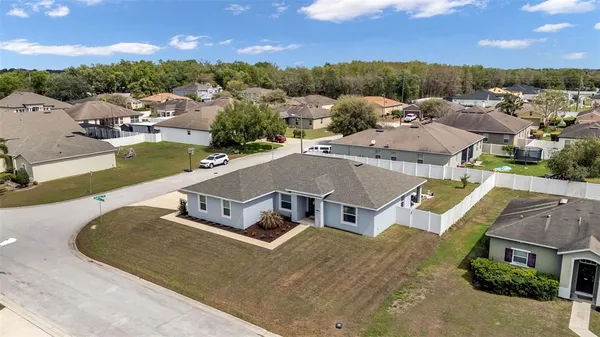 an aerial view of a house with a swimming pool