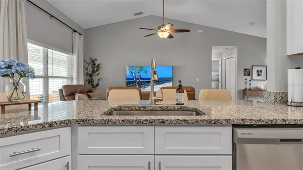 a kitchen with granite countertop kitchen island granite countertop stainless steel appliances a sink and a counter space
