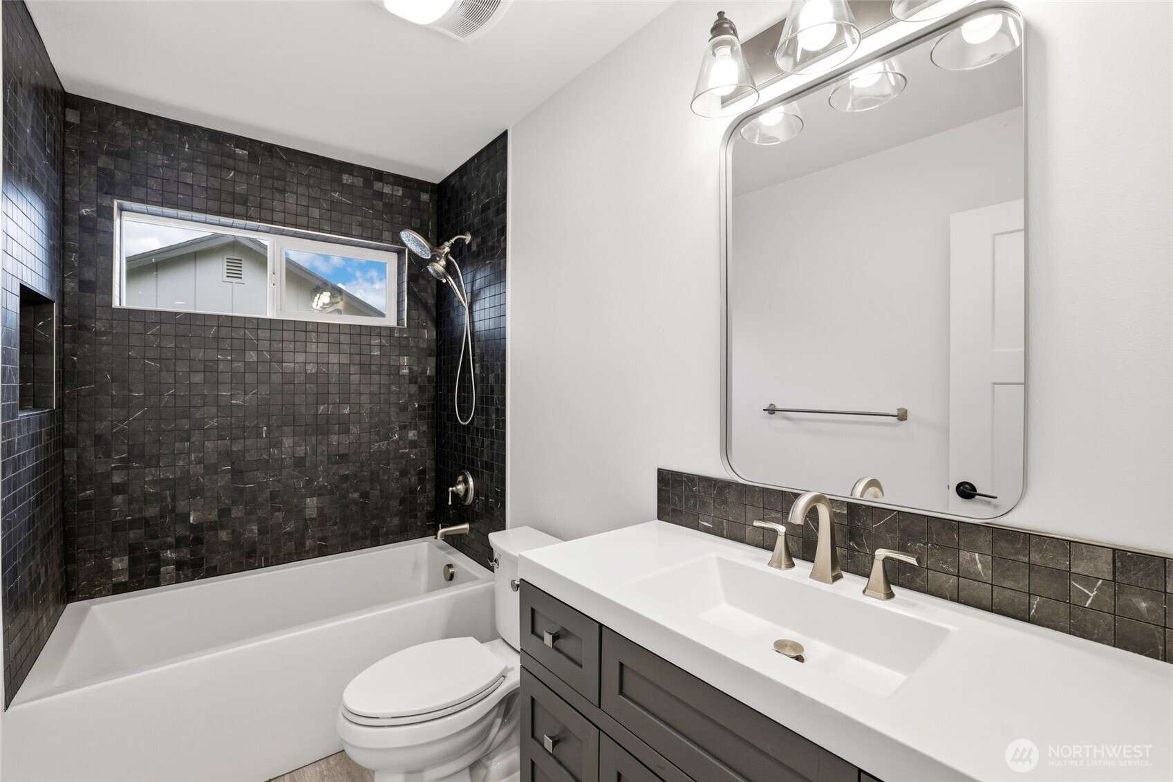 9815 178th Way Southwest Rochester, WA 98579 - Photo 28 of 36 a bathroom with a bathtub shower sink vanity mirror and toilet
