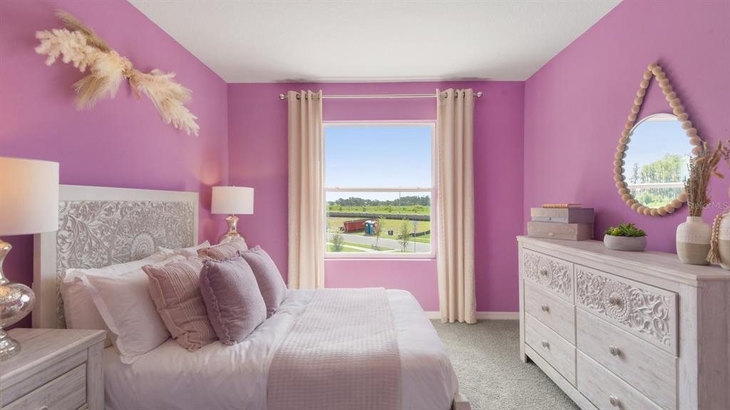 32463 Welling Blade Loop Wesley Chapel, FL 33545 - Photo 24 of 42 a bed room with a bed and a dresser