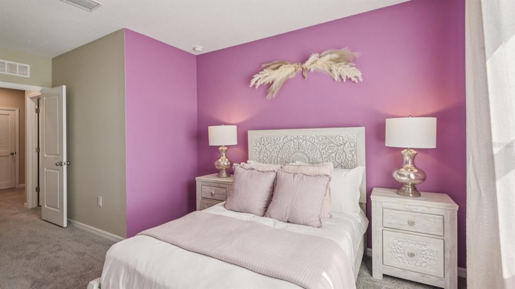 32463 Welling Blade Loop Wesley Chapel, FL 33545 - Photo 25 of 42 a bedroom with a bed and a dresser