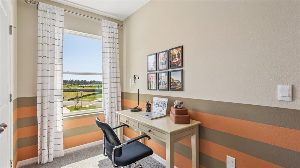 32463 Welling Blade Loop Wesley Chapel, FL 33545 - Photo 30 of 42 a workspace with furniture and window