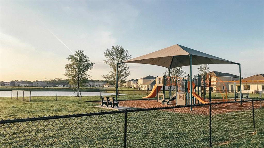 32463 Welling Blade Loop Wesley Chapel, FL 33545 - Photo 39 of 42 a view of a park with swings and slides