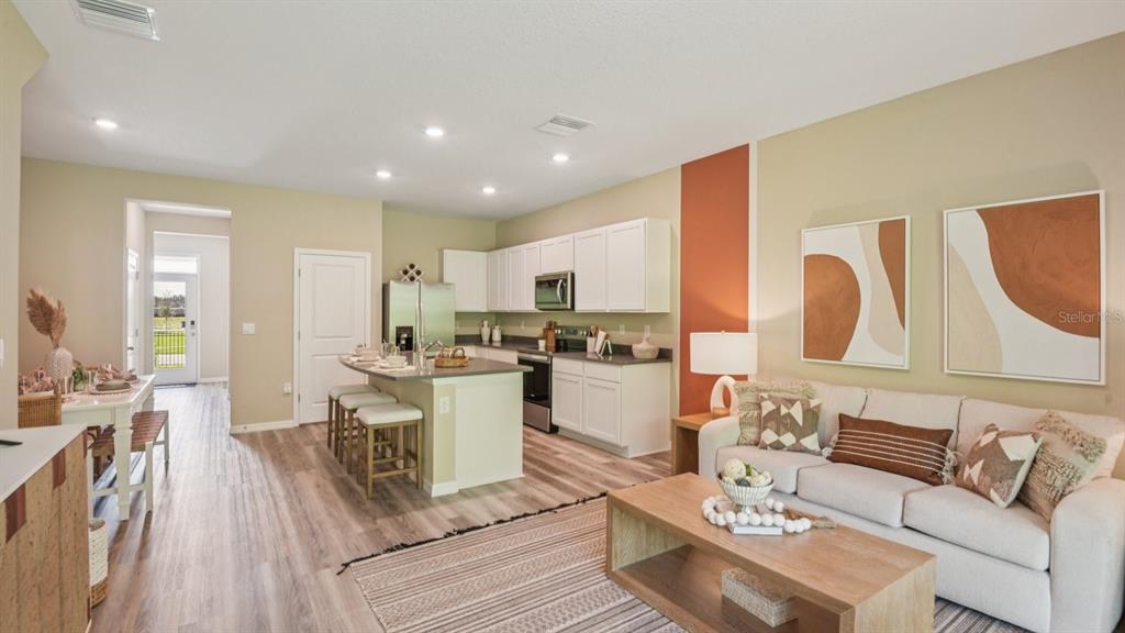 32463 Welling Blade Loop Wesley Chapel, FL 33545 - Photo 6 of 42 a living room with furniture kitchen view and a large window