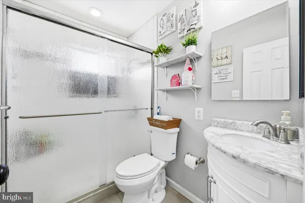 a bathroom with a sink mirror and toilet