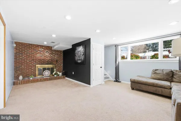 a spacious bedroom with furniture and a fireplace