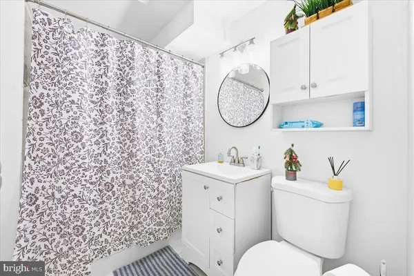 a bathroom with a sink a toilet and a mirror