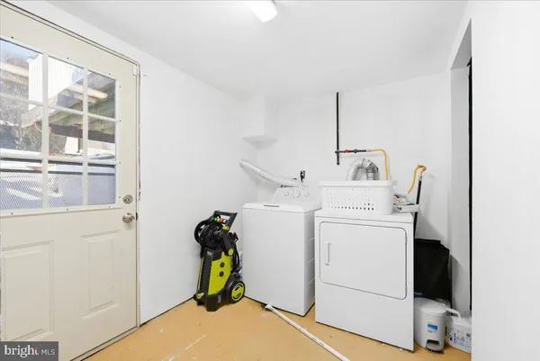 a view of storage and utility room with washer and dryer
