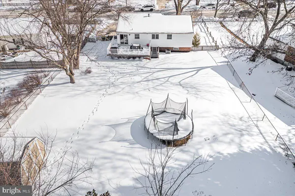 a view of a house with snow on the road