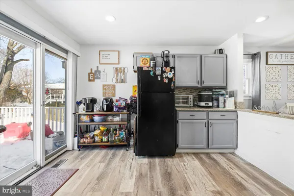 a kitchen with refrigerator and window