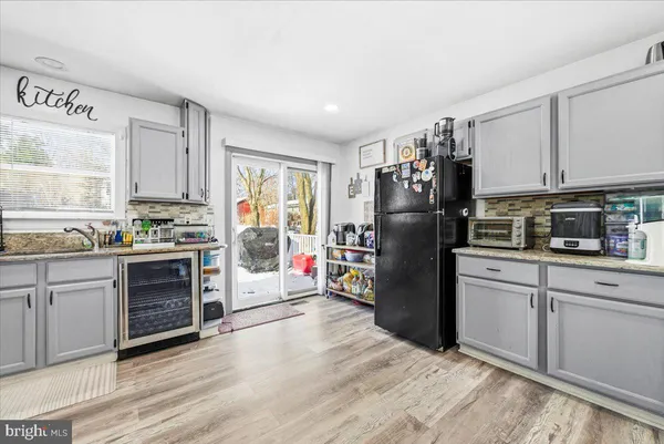 a kitchen with a refrigerator stove and wooden cabinets