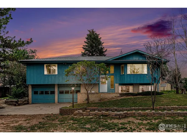 a view of a brick house with a yard