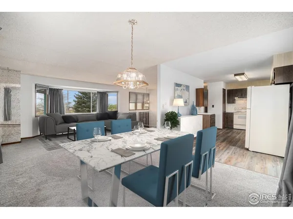 a view of a kitchen with a sink and refrigerator
