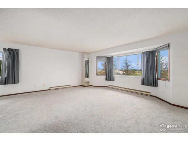 a view of a dining room with furniture and a chandelier