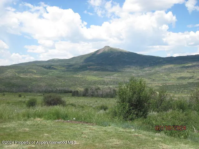 a view of a field with an ocean