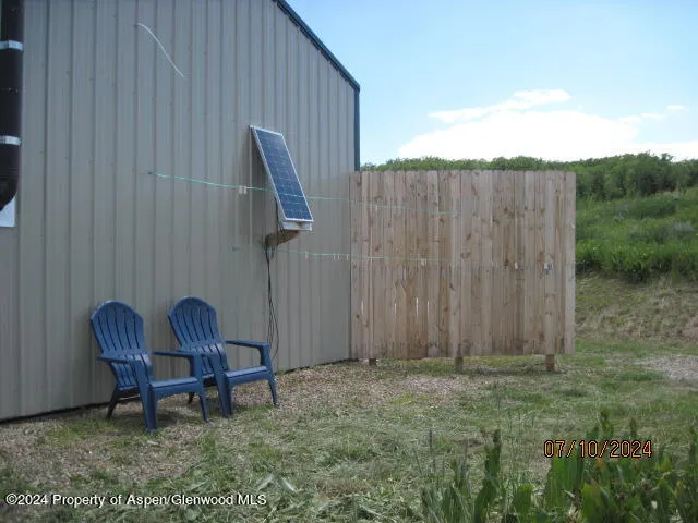a view of a backyard with a patio and outdoor seating