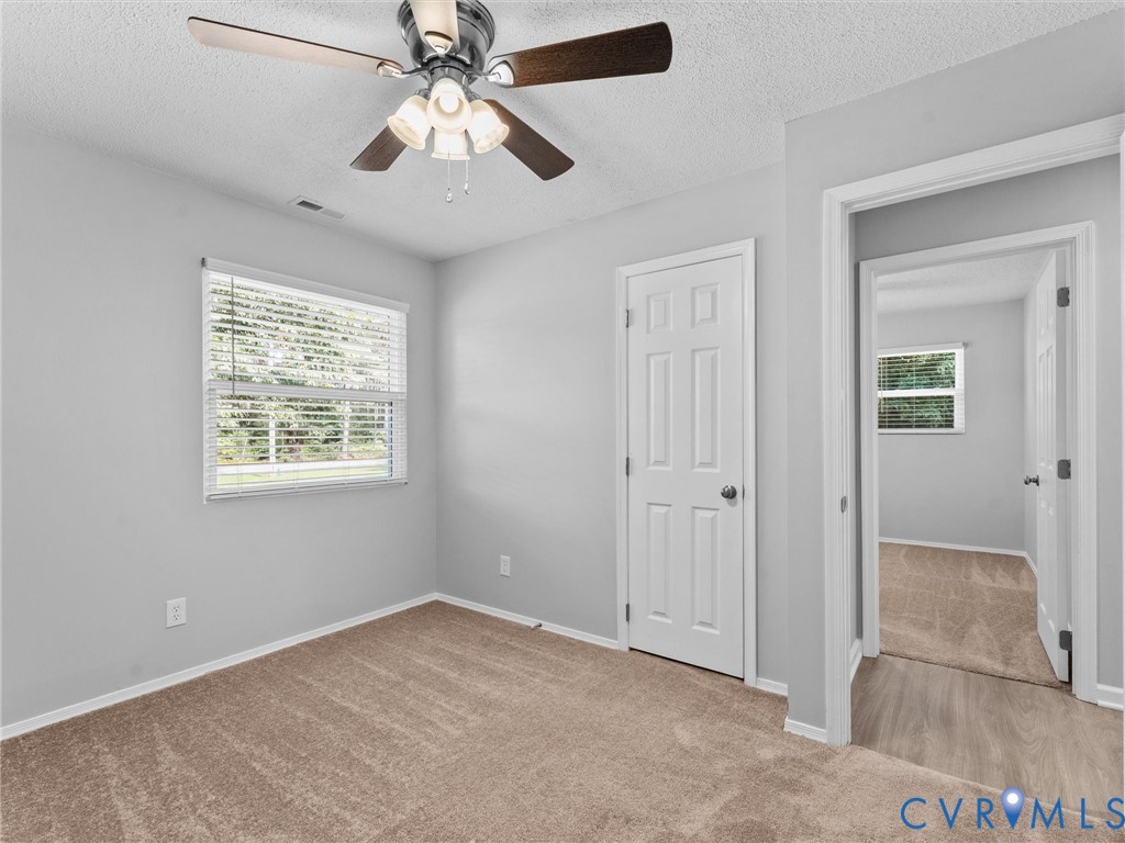 6927 Carsley Road Waverly, VA 23890 - Photo 22 of 51 Neutral wall paint, ceiling fan with integrated li