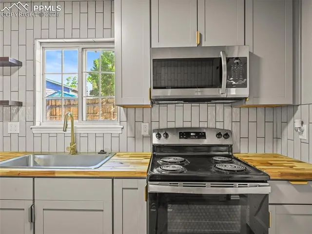 a kitchen with a stove and a sink