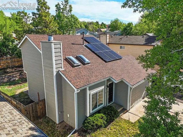 a aerial view of a house with a yard