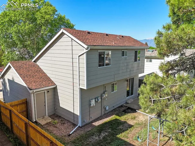 a view of a house with wooden fence