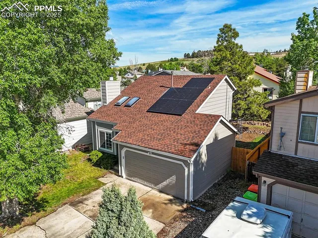 an aerial view of a house with a yard