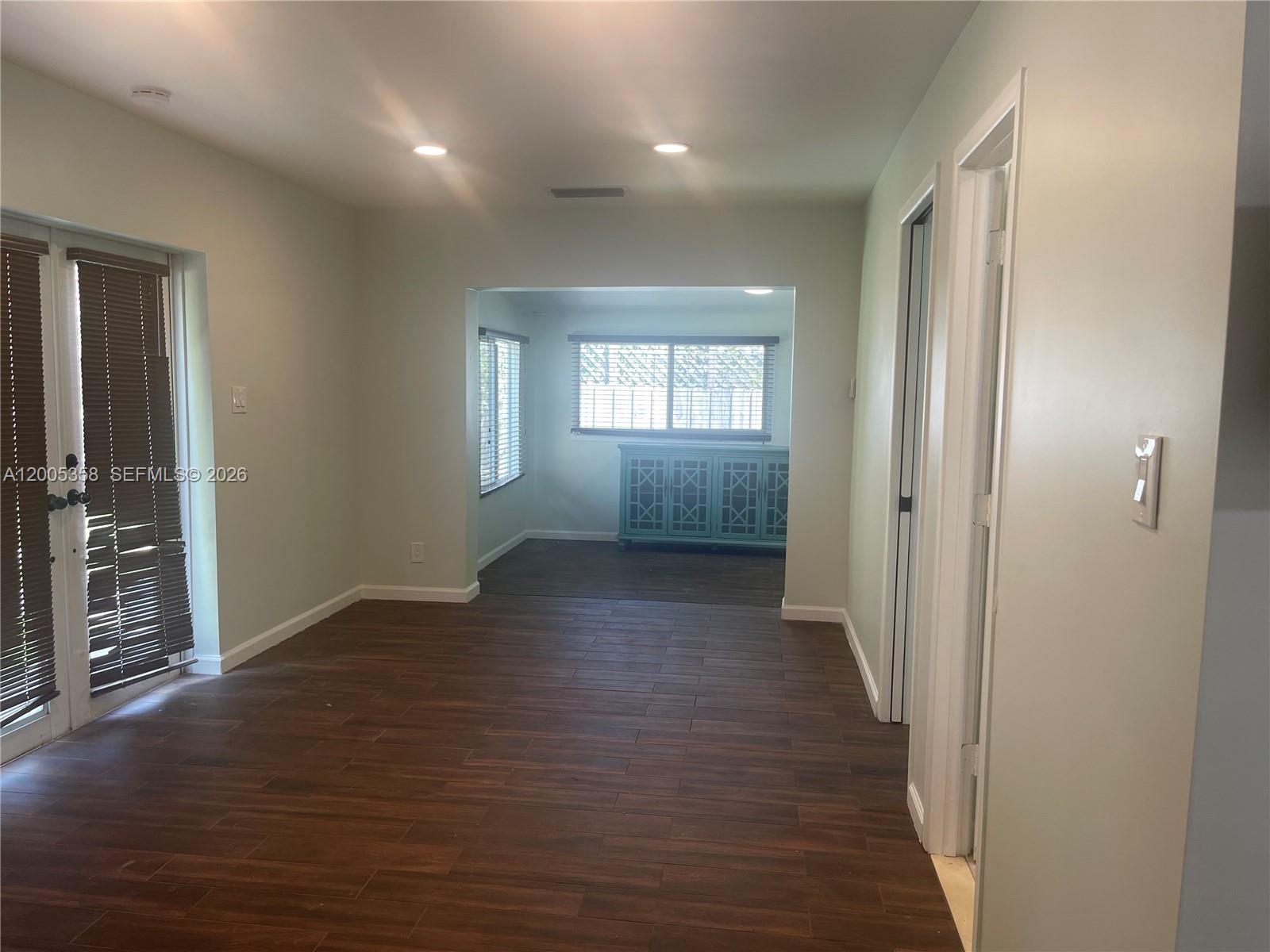 554 Northeast 74th Street, Unit 2 Miami, FL 33138 - Photo 13 of 30 an empty room with wooden floor and windows
