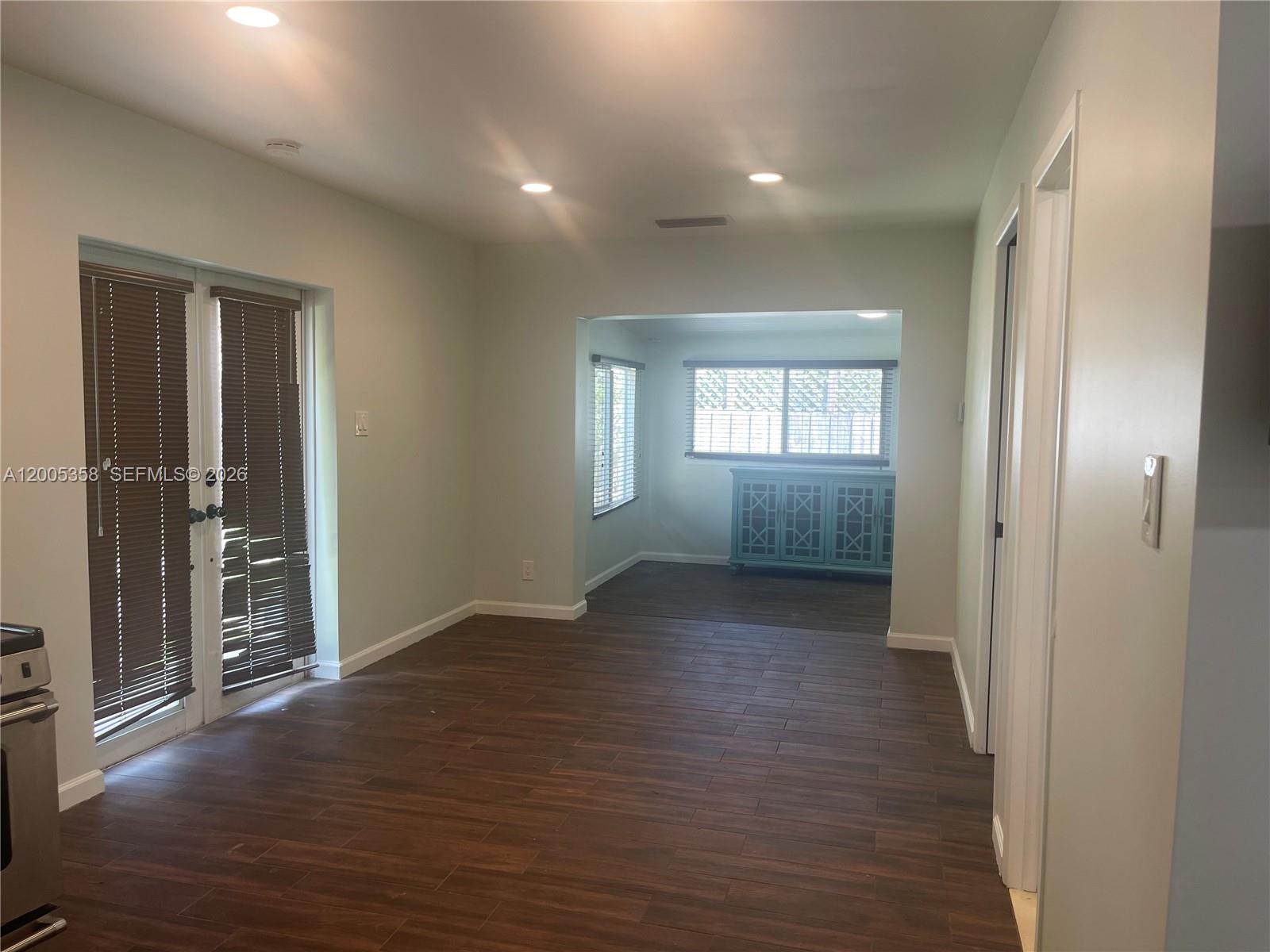 554 Northeast 74th Street, Unit 2 Miami, FL 33138 - Photo 14 of 30 an empty room with wooden floor and windows