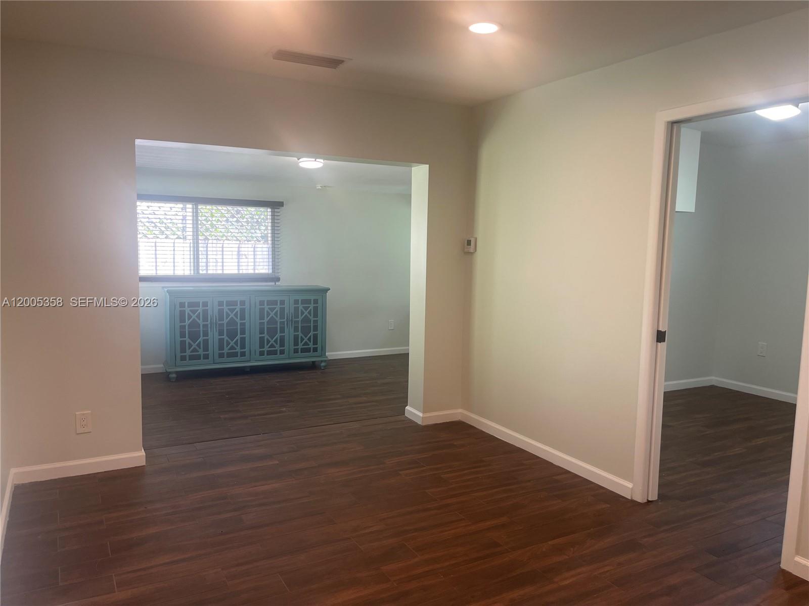 554 Northeast 74th Street, Unit 2 Miami, FL 33138 - Photo 15 of 30 an empty room with wooden floor and windows