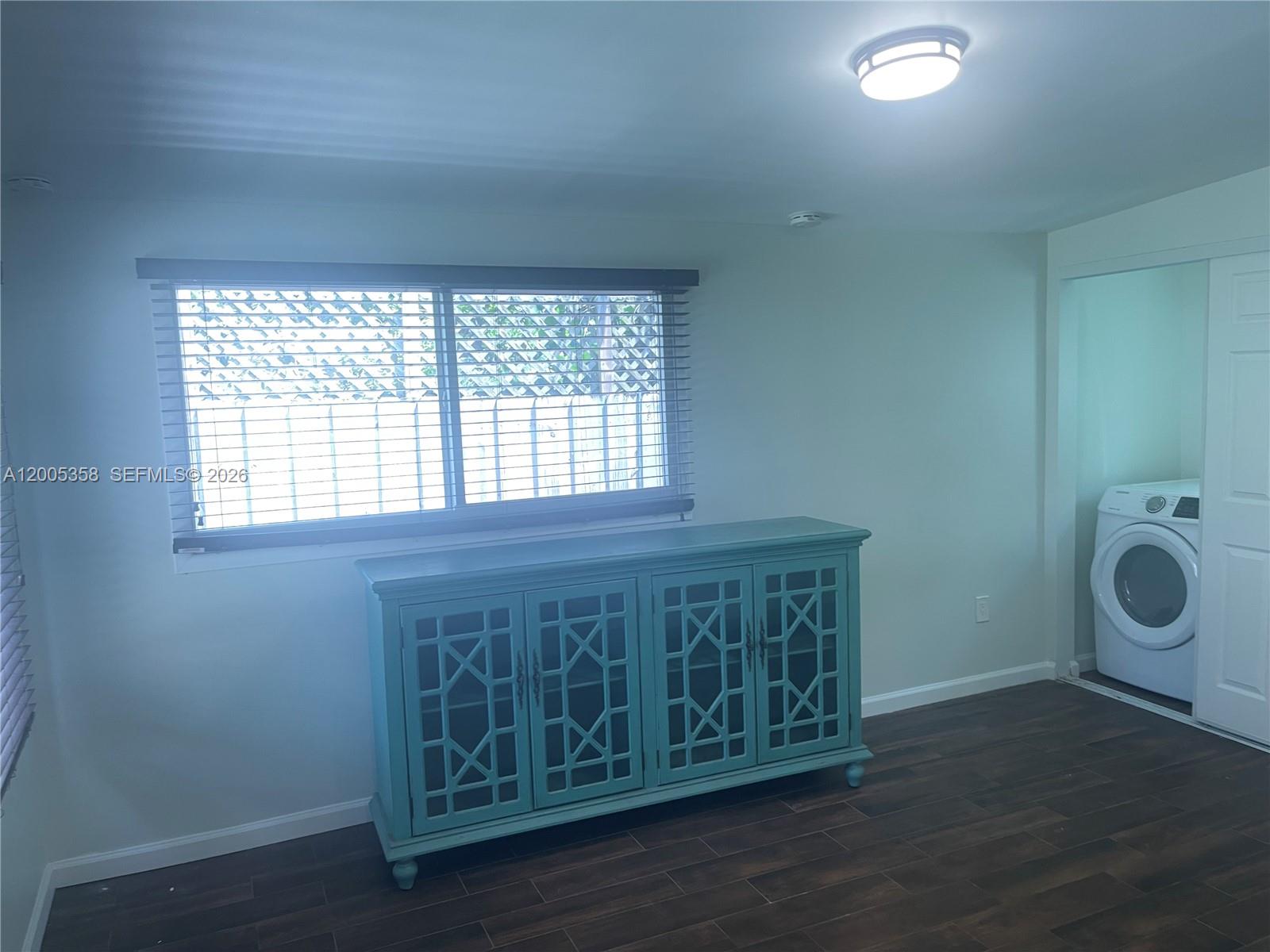 554 Northeast 74th Street, Unit 2 Miami, FL 33138 - Photo 16 of 30 a view of a room with wooden floor and windows