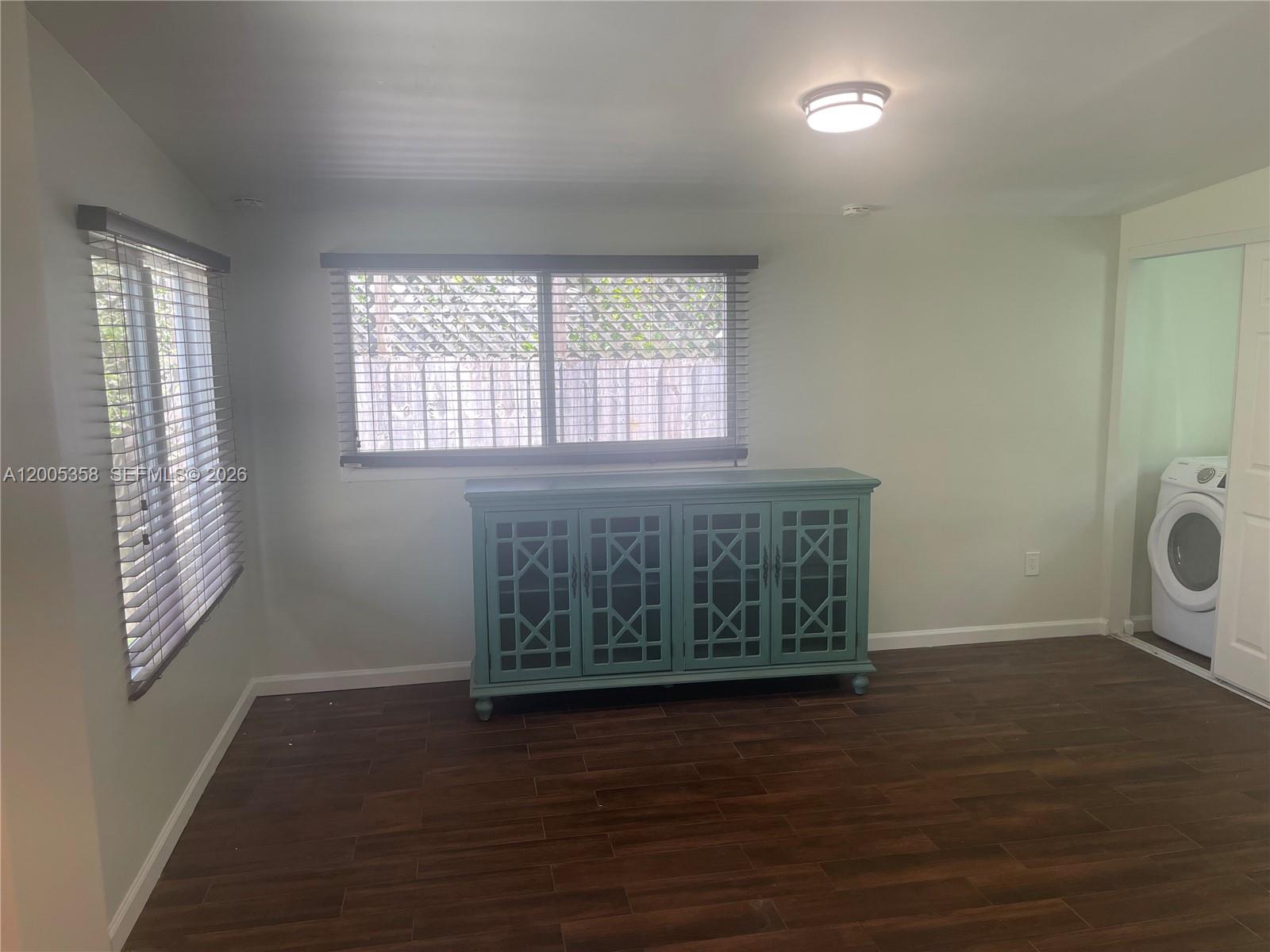 554 Northeast 74th Street, Unit 2 Miami, FL 33138 - Photo 18 of 30 an empty room with wooden floor and windows