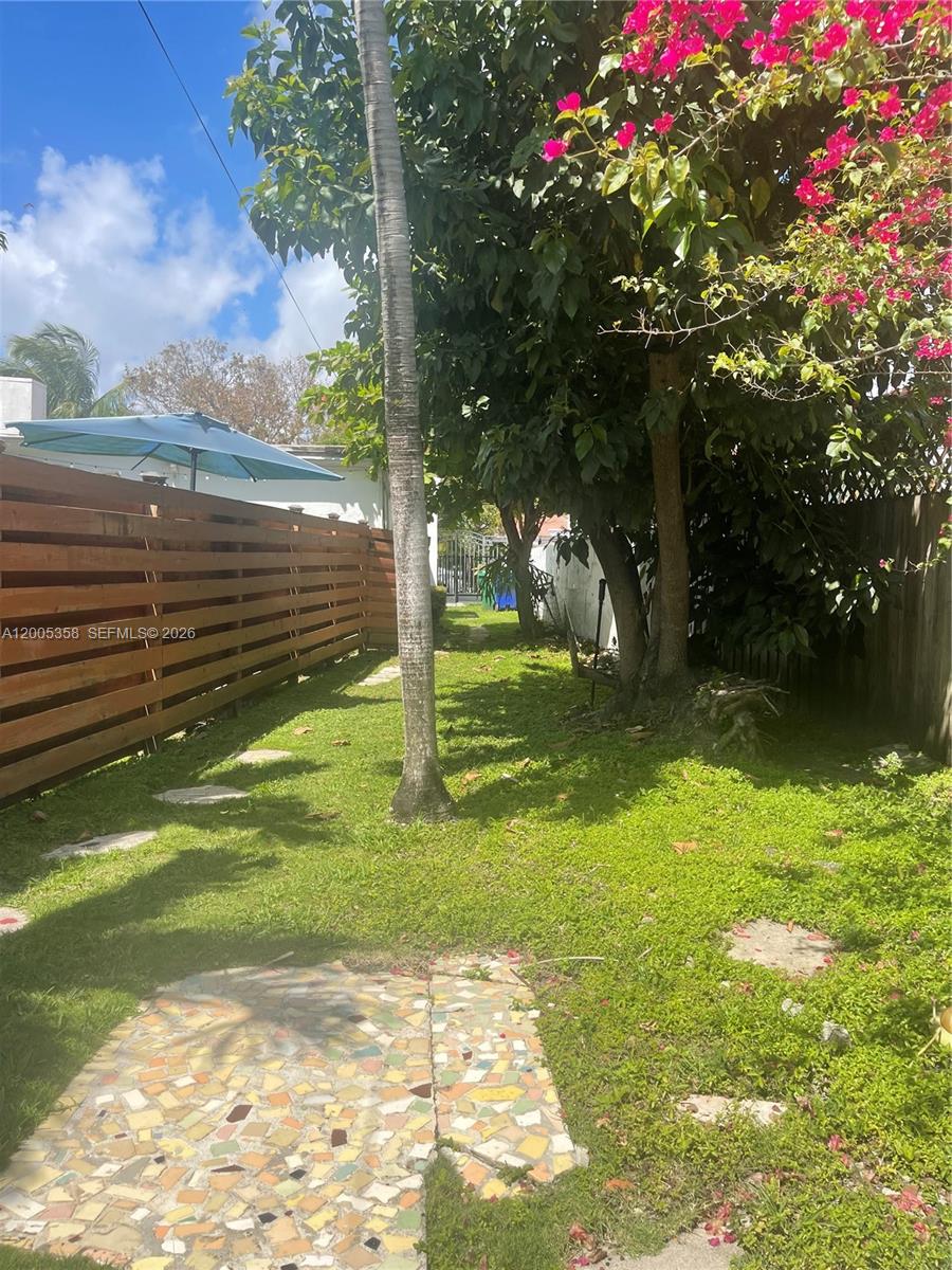 554 Northeast 74th Street, Unit 2 Miami, FL 33138 - Photo 26 of 30 a view of a garden with a tree