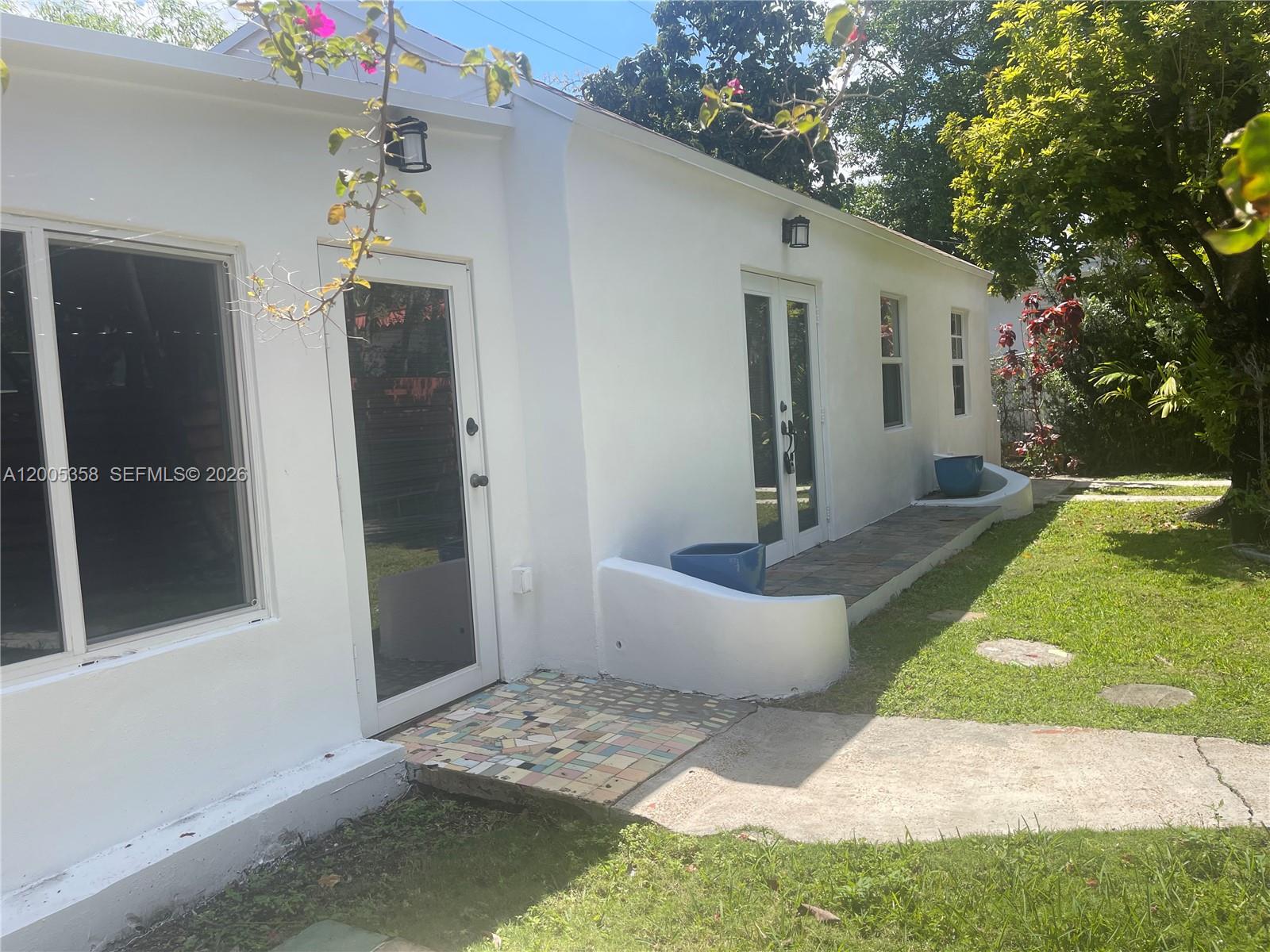 554 Northeast 74th Street, Unit 2 Miami, FL 33138 - Photo 27 of 30 a front view of a house with garden