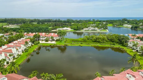 a view of a lake with a house in the background