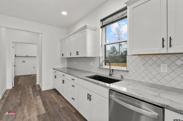 a kitchen with a sink and cabinets