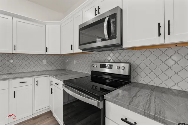 a kitchen with wooden cabinets and a stove top oven