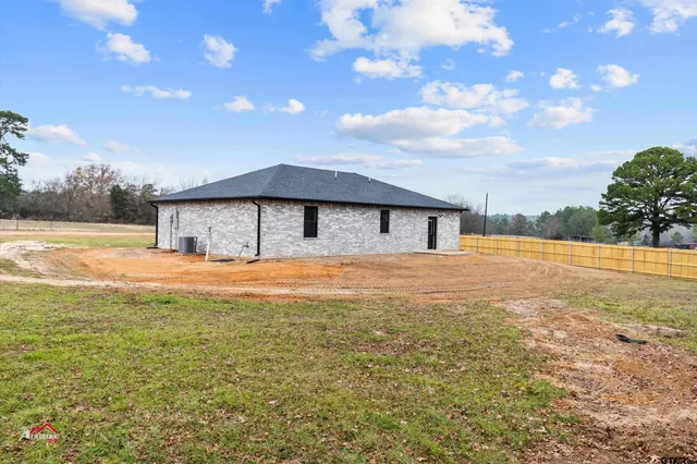 a house with swimming pool in front of it