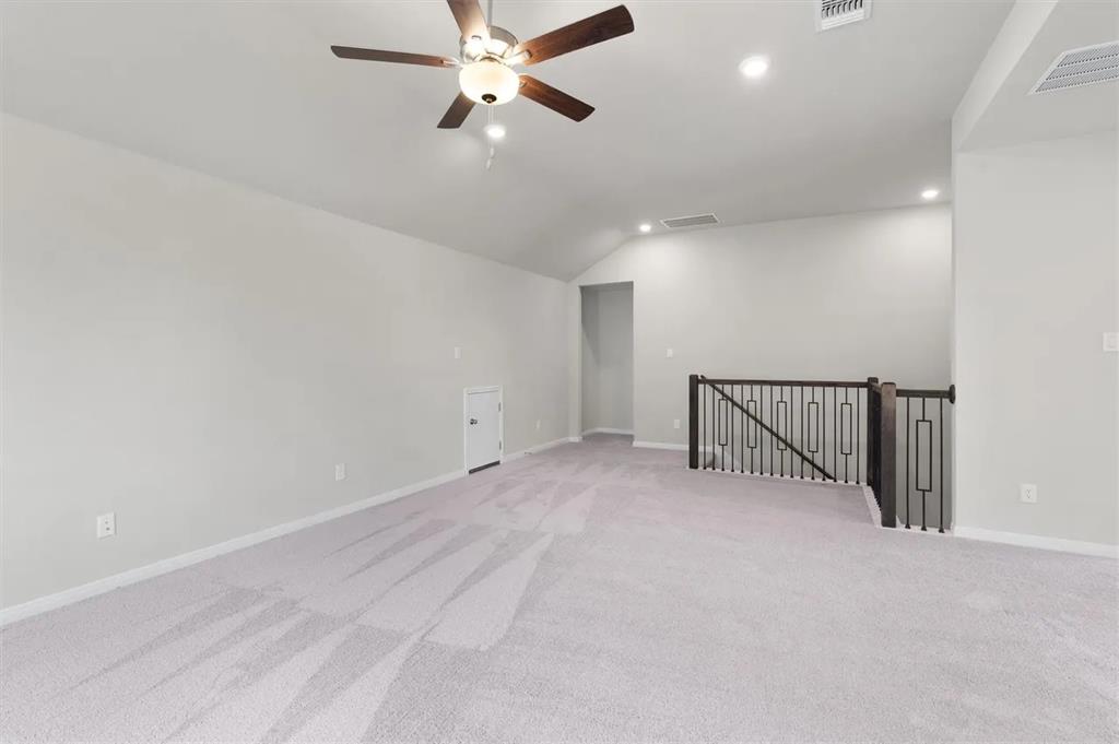 332 Stellar Wind Drive Georgetown, TX 78628 - Photo 21 of 29 A spacious upstairs recreation area with vaulted ceilings awaits customization.