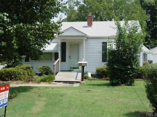 1319 Curfman Street Raleigh, NC 27603 - Photo 1 of 1 a front view of a house with a yard and trees