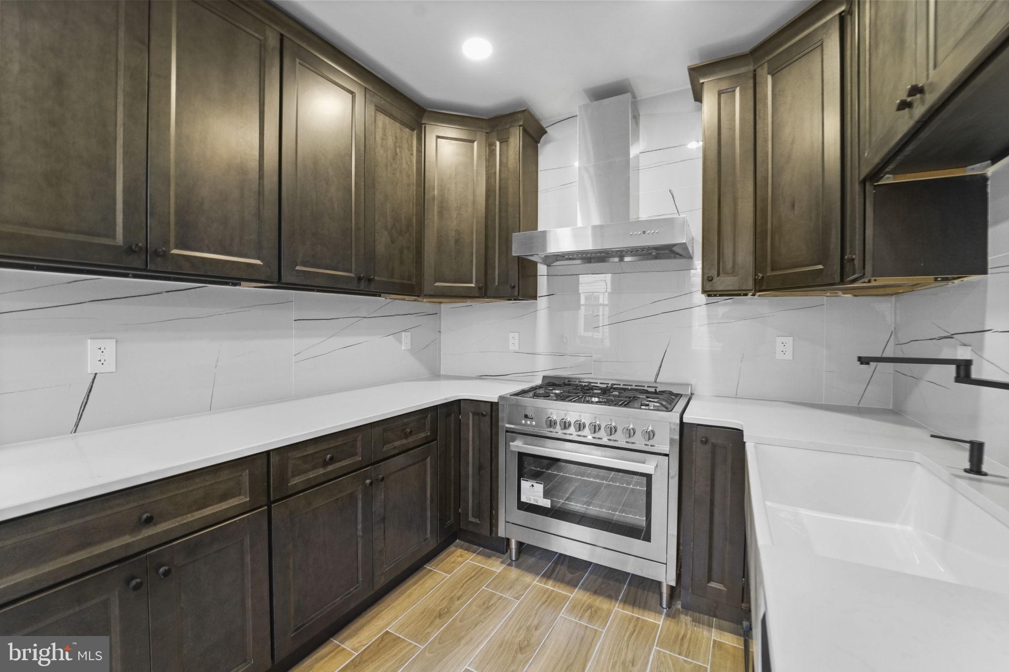 121 Parker Place Hamilton, NJ 08609 - Photo 12 of 37 a kitchen with sink cabinets and stainless steel appliances