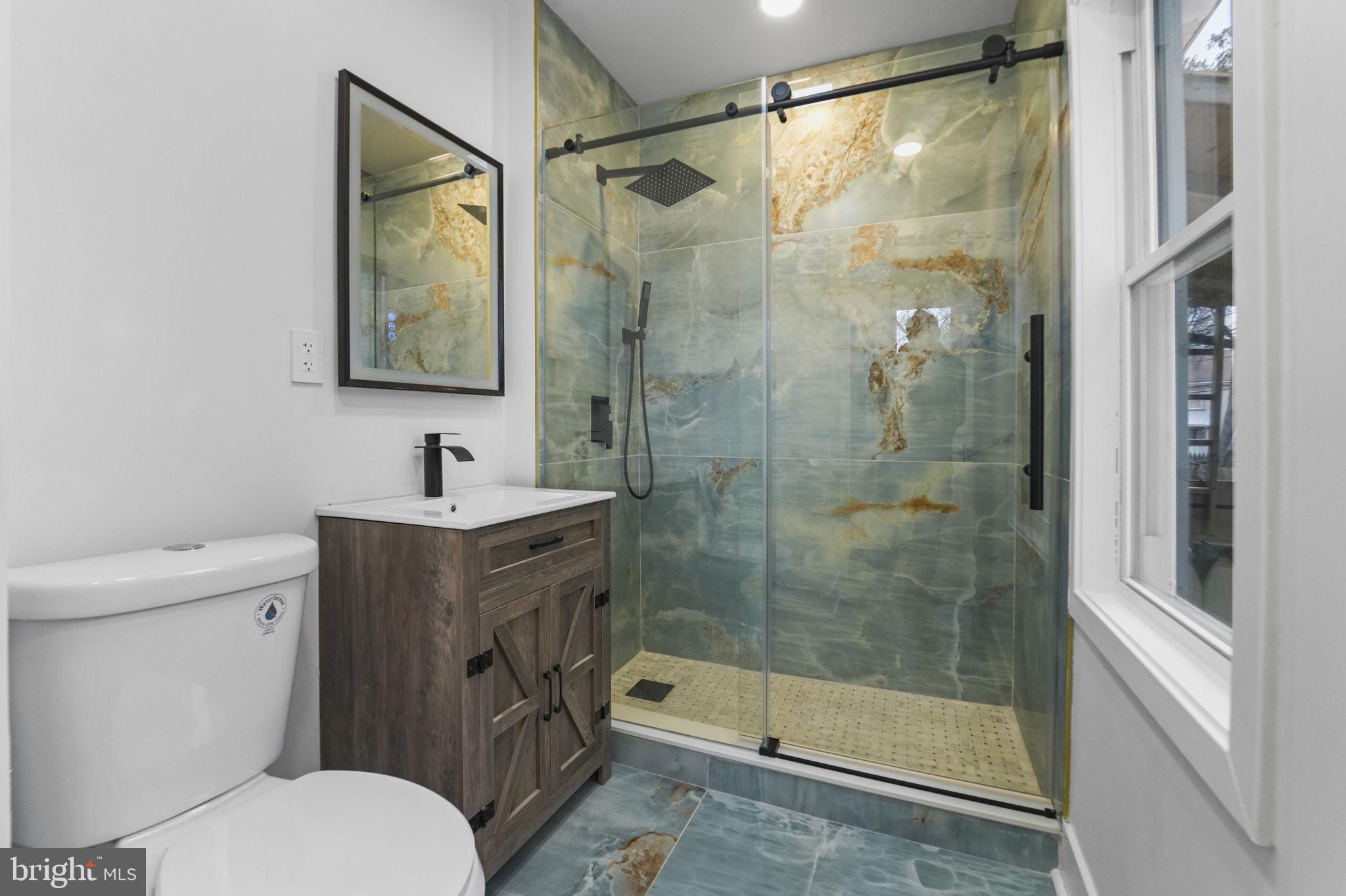 121 Parker Place Hamilton, NJ 08609 - Photo 16 of 37 a bathroom with a shower sink mirror and toilet