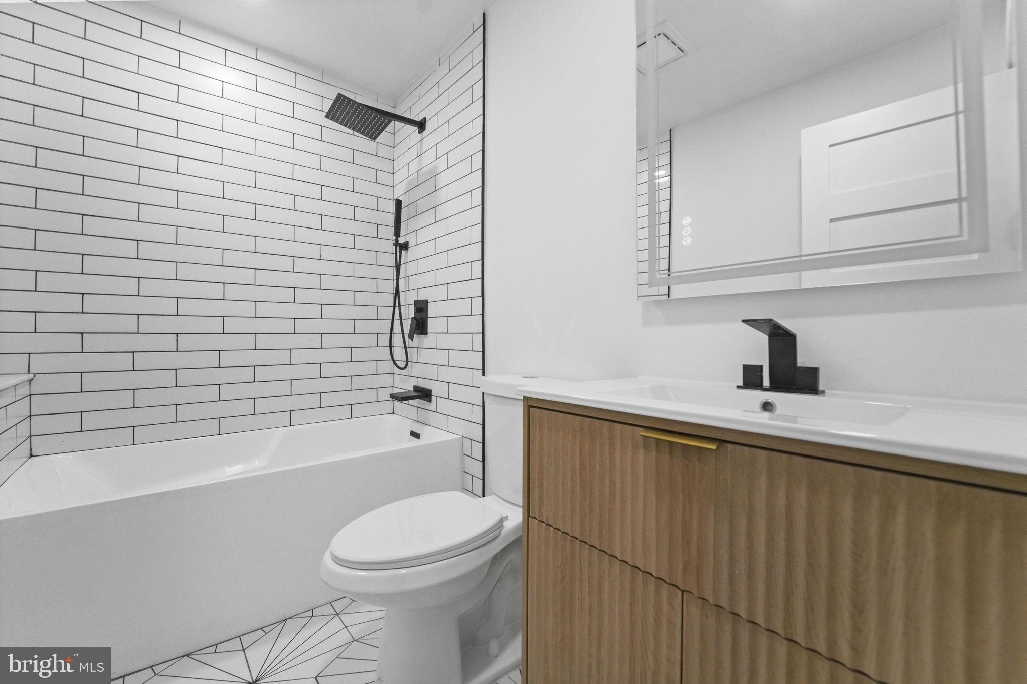 121 Parker Place Hamilton, NJ 08609 - Photo 19 of 37 a bathroom with a sink a toilet and bathtub