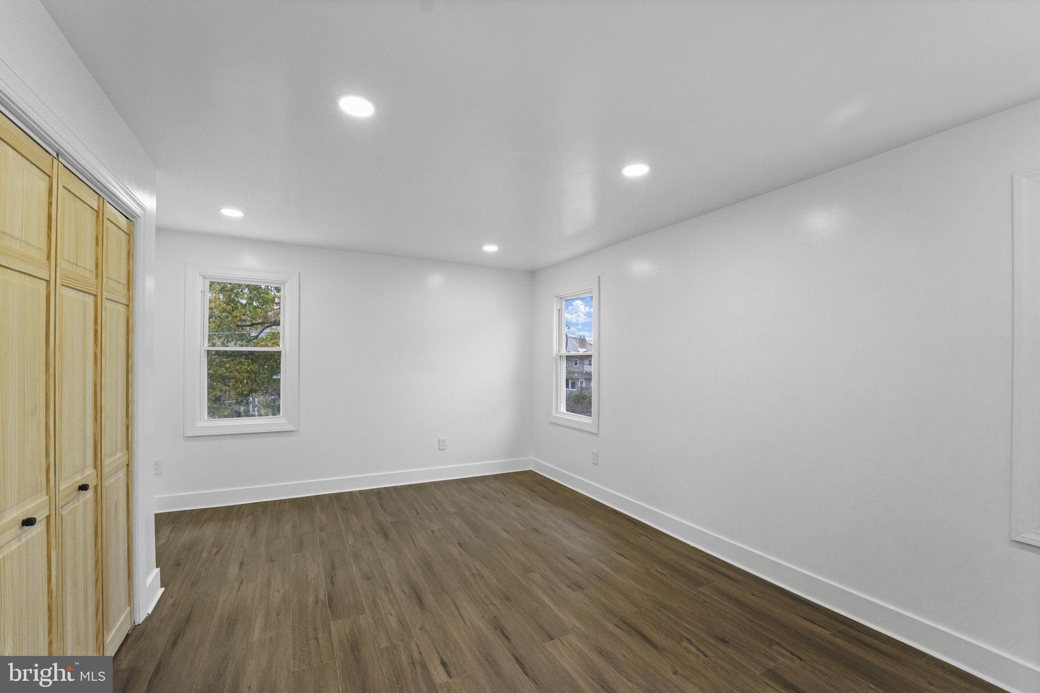 121 Parker Place Hamilton, NJ 08609 - Photo 21 of 37 an empty room with wooden floor and windows