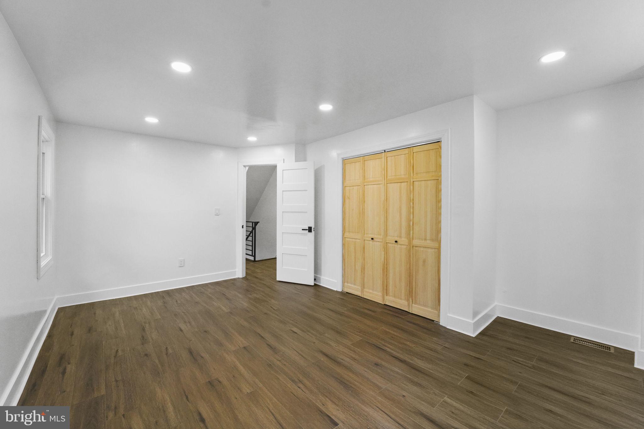 121 Parker Place Hamilton, NJ 08609 - Photo 23 of 37 a view of an empty room with wooden floor and a window