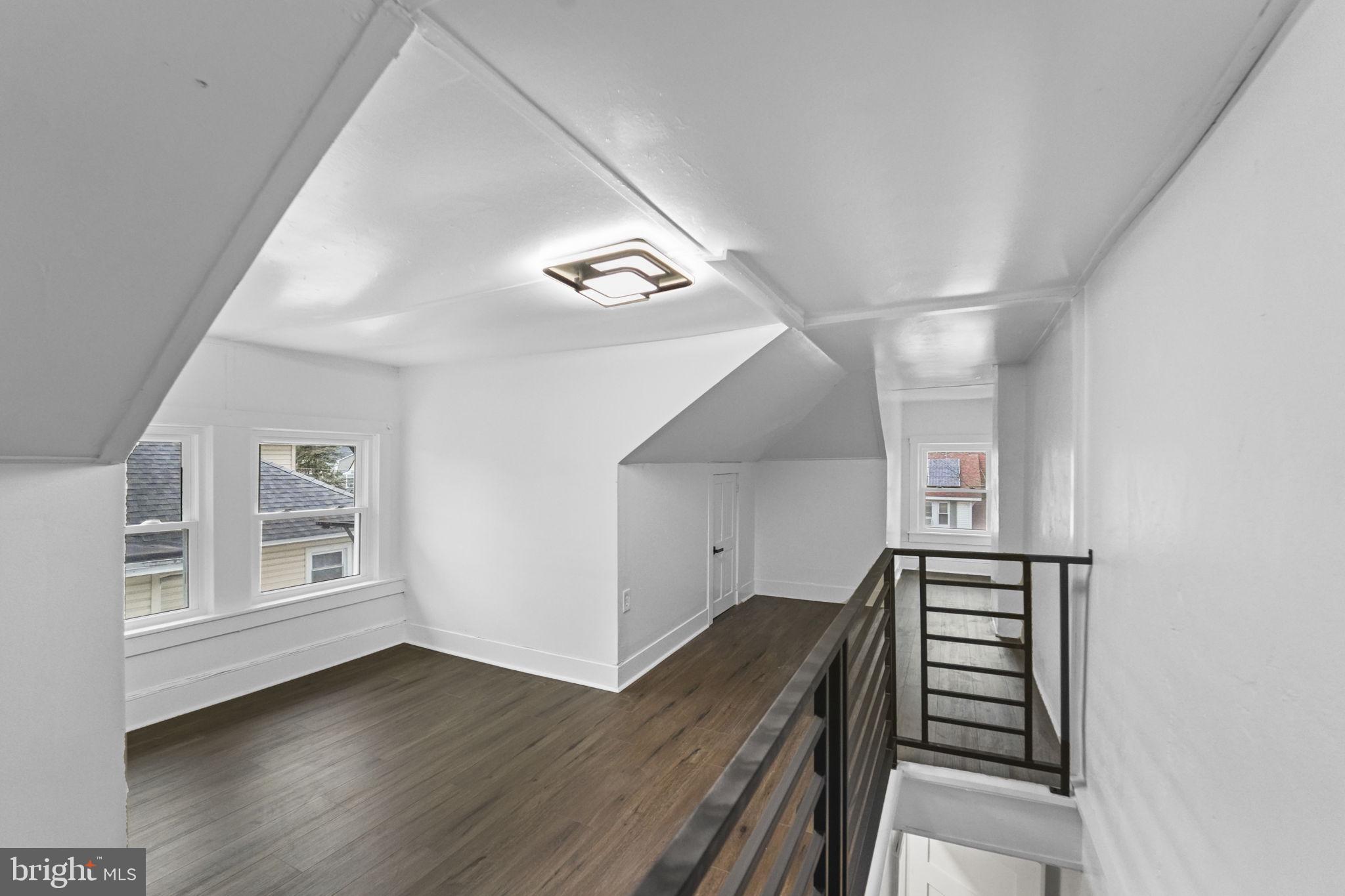 121 Parker Place Hamilton, NJ 08609 - Photo 29 of 37 a view of an empty room with wooden floor and stairs