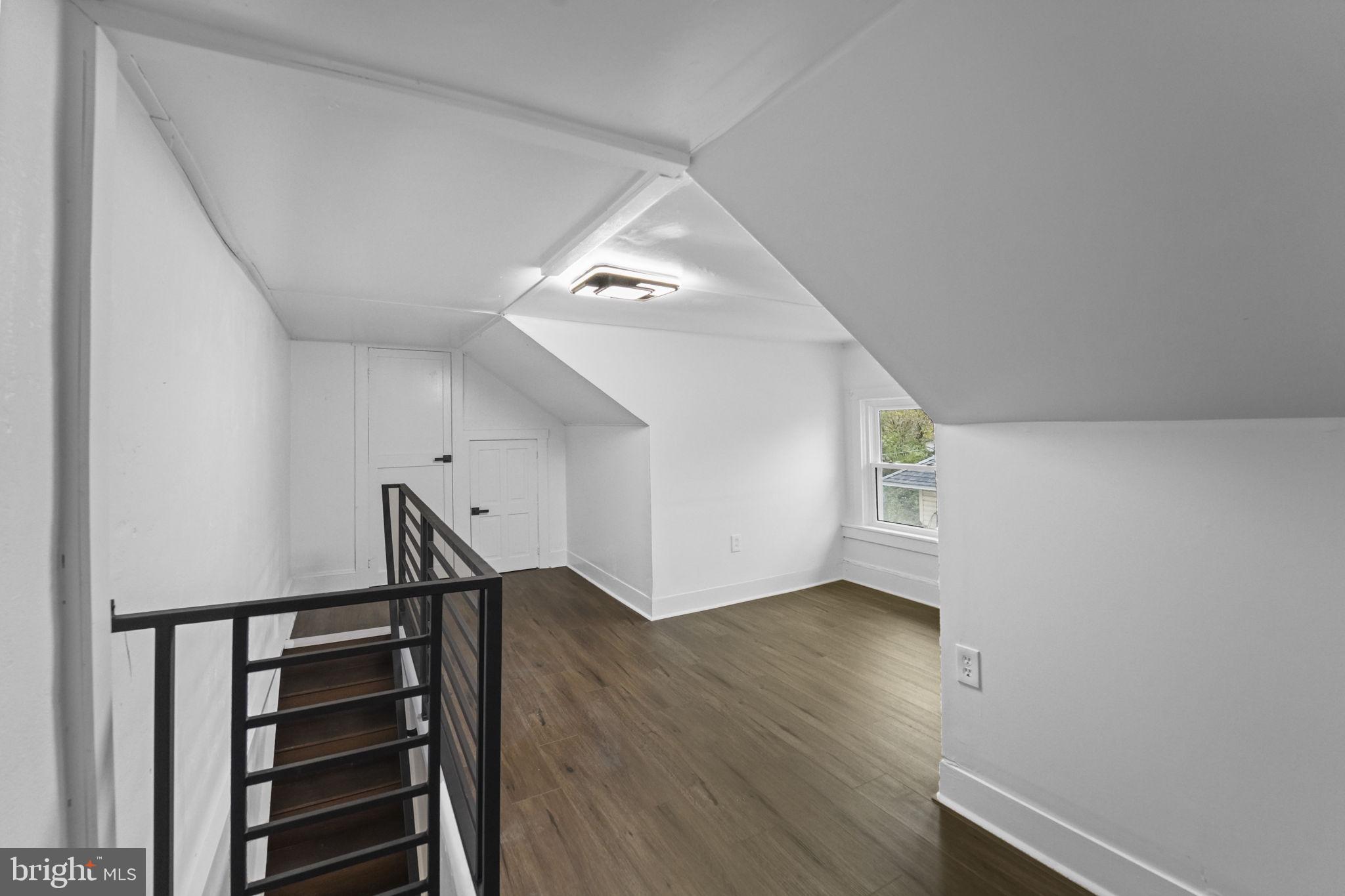 121 Parker Place Hamilton, NJ 08609 - Photo 30 of 37 a view of an empty room with wooden floor and stairs