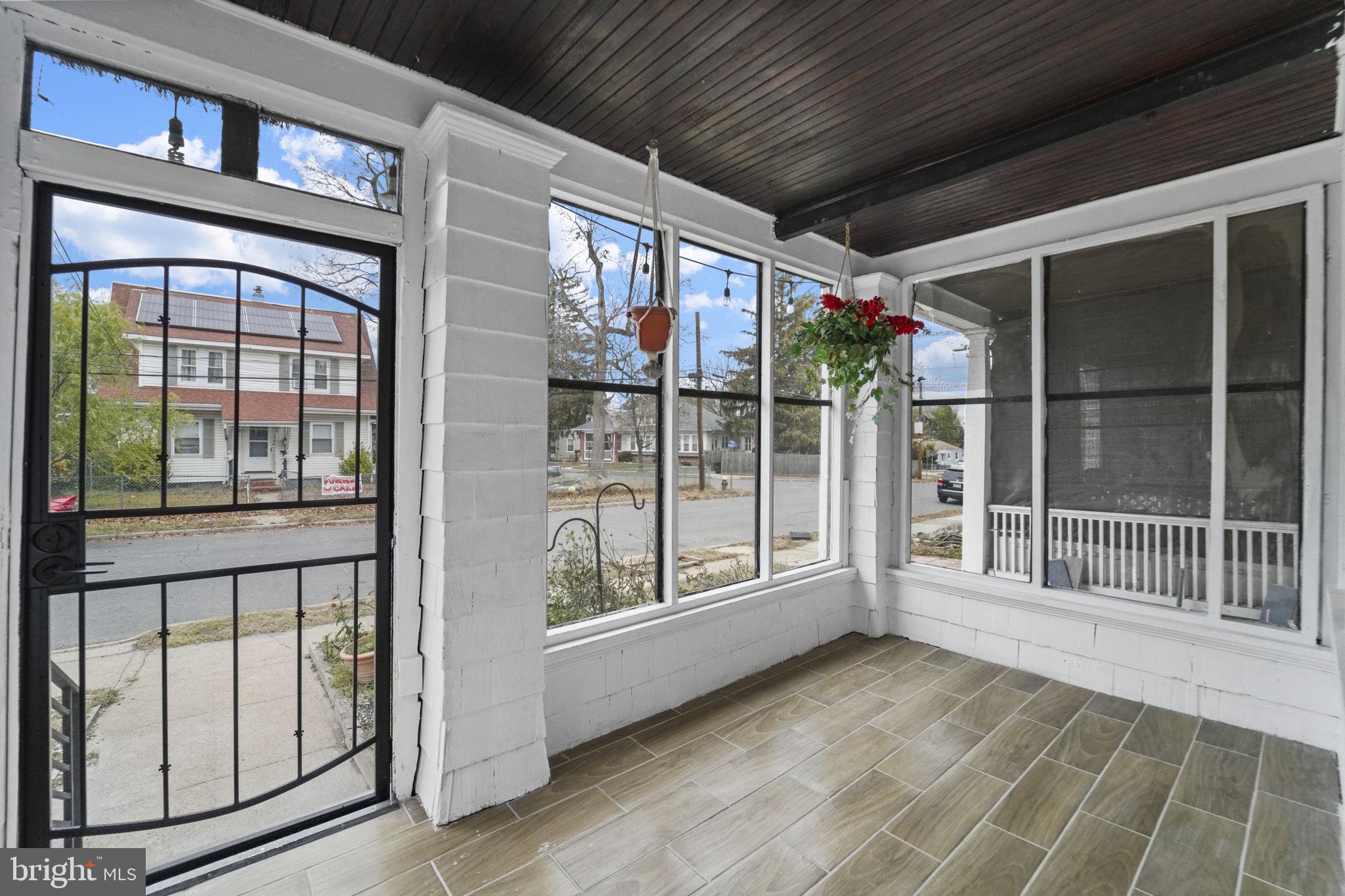 121 Parker Place Hamilton, NJ 08609 - Photo 31 of 37 a view of a porch with wooden floor and iron stairs